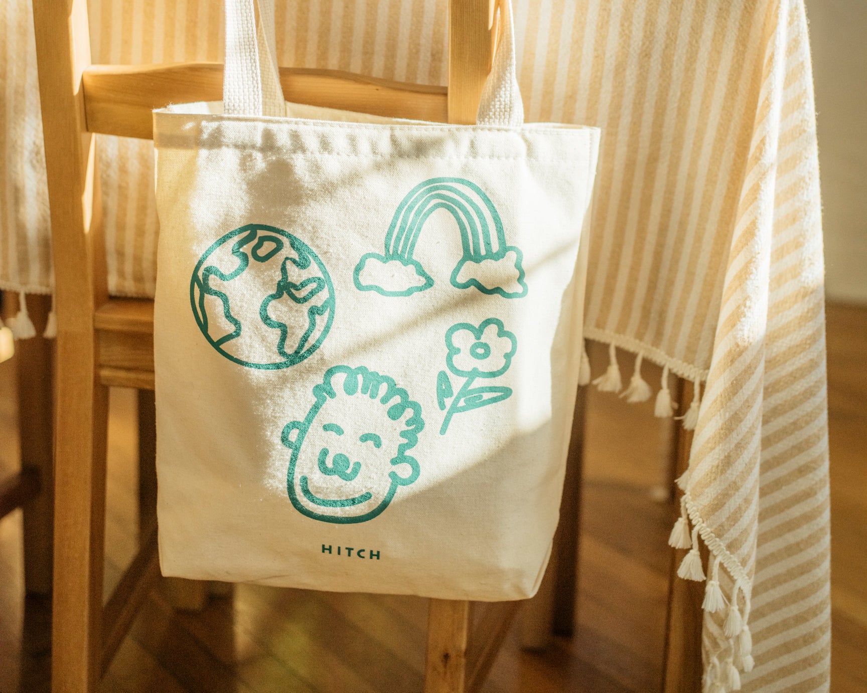 Hitch Climate Tote hanging on the back of a wooden chair