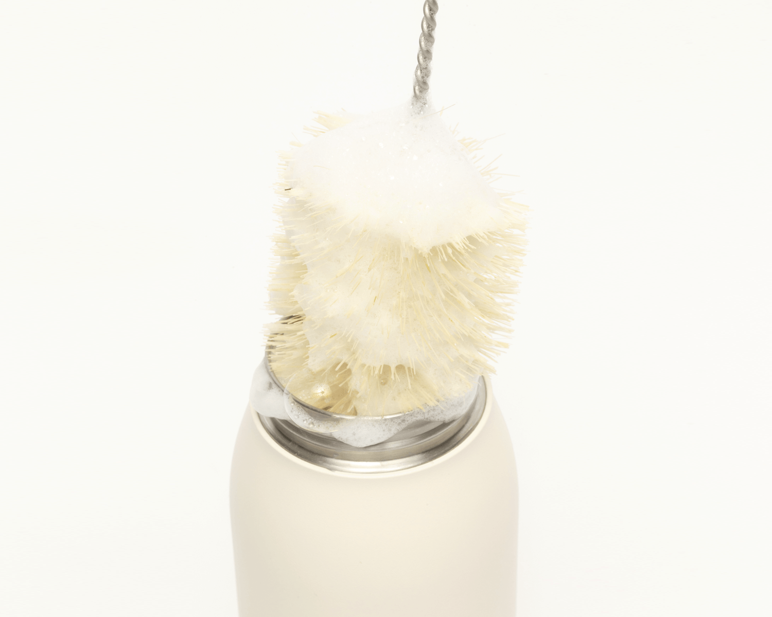 Hitch Bottle Brush creating suds inside the Hitch Bottle and Cup in Natural White