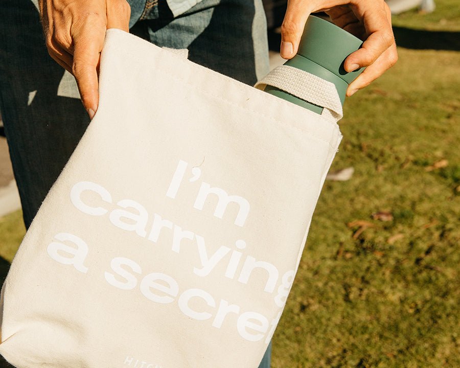 Hitch Bottle slide into canvas Hitch Tote that says I'm Carrying A Secret